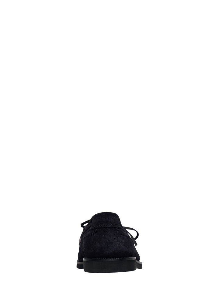 JW Anderson black suede boat loafer with lace-up vamp, silver ring hardware, and chunky ridged rubber outsole, shown in profile view - view 3