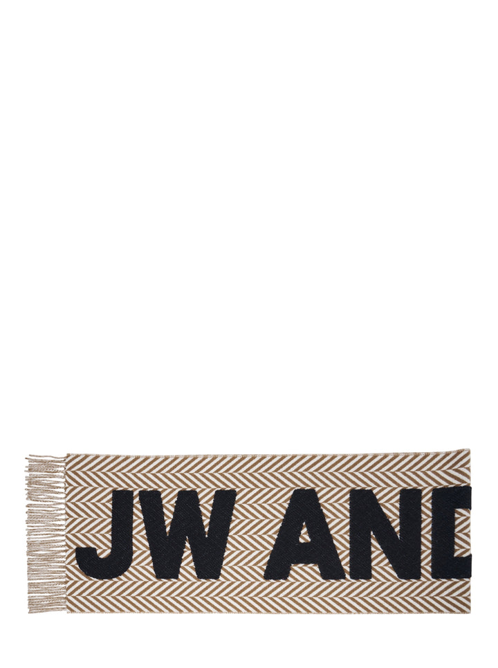 JW Anderson Logo Fil Coupé Check Scarf in tan and ivory herringbone stripe with oversized black logo lettering and fringe trim at both ends