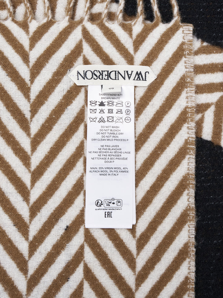 JW Anderson Logo Fil Coupé Check Scarf in tan and ivory herringbone stripe with oversized black logo lettering and fringe trim at both ends - view 3
