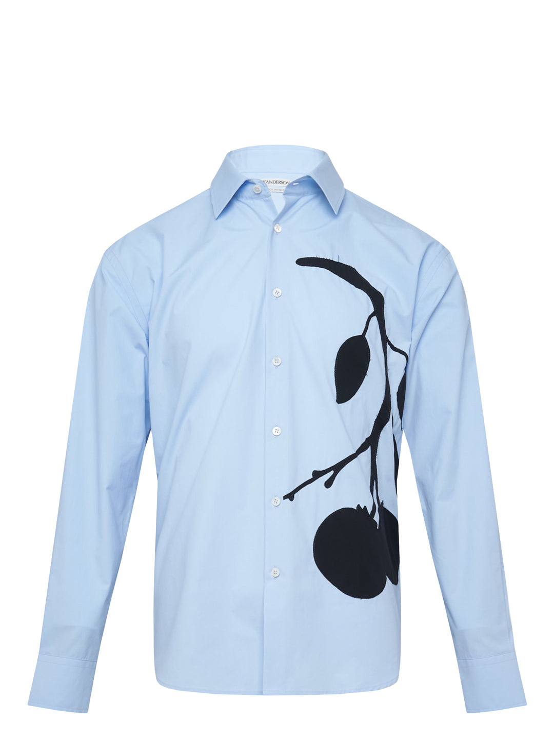 JW Anderson sky blue long-sleeve cotton shirt featuring an oversized black persimmon branch appliqué motif across the front, with white button fastening and point collar