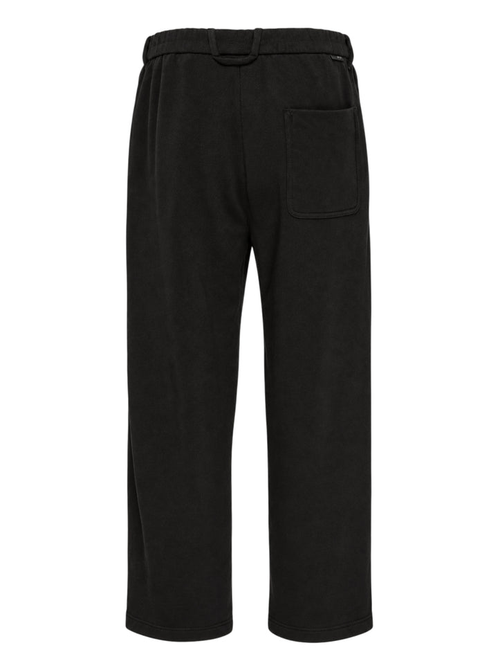 Solid Homme Easy Zip Pocket Sweatpants in washed black, featuring a relaxed wide-leg silhouette, zip side pockets, articulated knee panelling, and a single button waistband closure - view 2