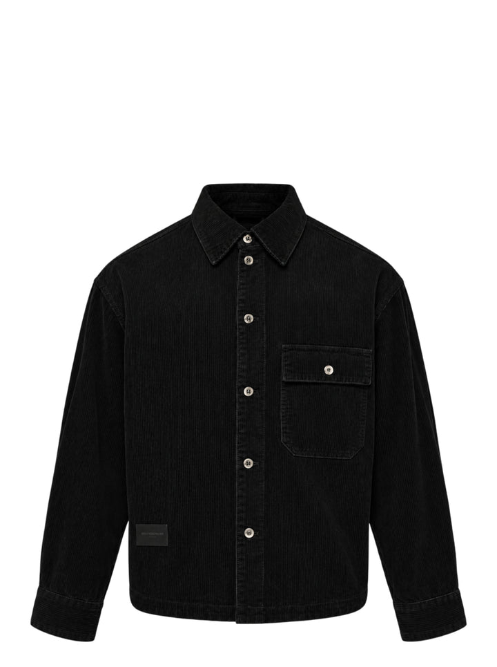 Wooyoungmi Washed Corduroy Overshirt in black, front view, showing ribbed texture, button fastening, chest pocket, and branding label at hem