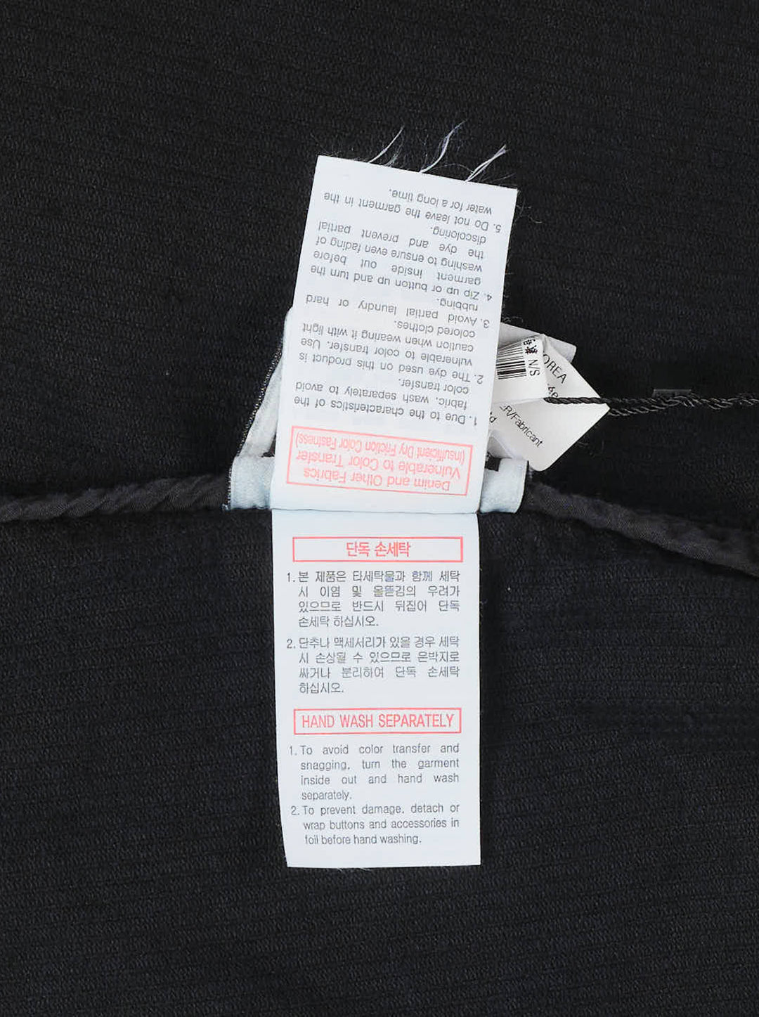 Wooyoungmi Washed Corduroy Overshirt in black, front view, showing ribbed texture, button fastening, chest pocket, and branding label at hem - view 3