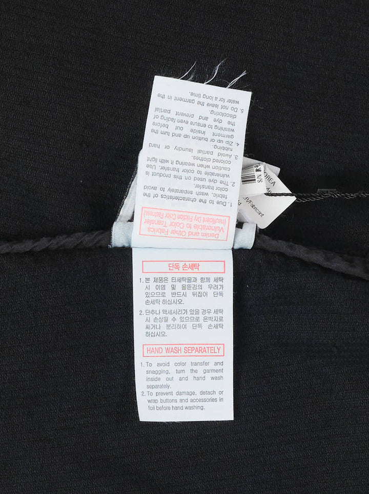 Wooyoungmi Washed Corduroy Overshirt in black, front view, showing ribbed texture, button fastening, chest pocket, and branding label at hem - view 3