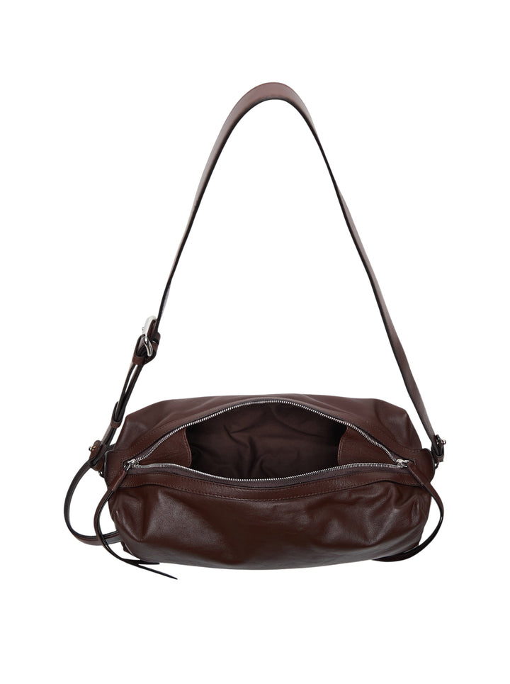 Lemaire Care Sling Bag in dark brown nappa lamb leather, cylindrical barrel shape with zip closure, leather tassel pull, and adjustable crossbody strap with gunmetal hardware - view 3