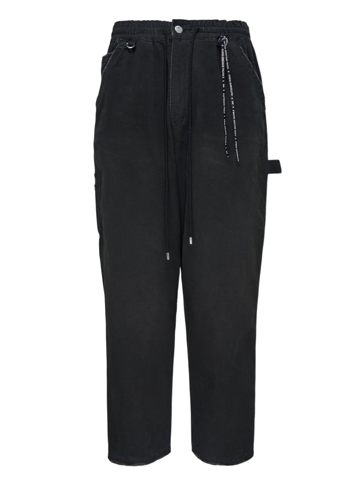 Mastermind stone washed straight easy pants in faded black with drawstring waist, hammer loop and branded cord detail