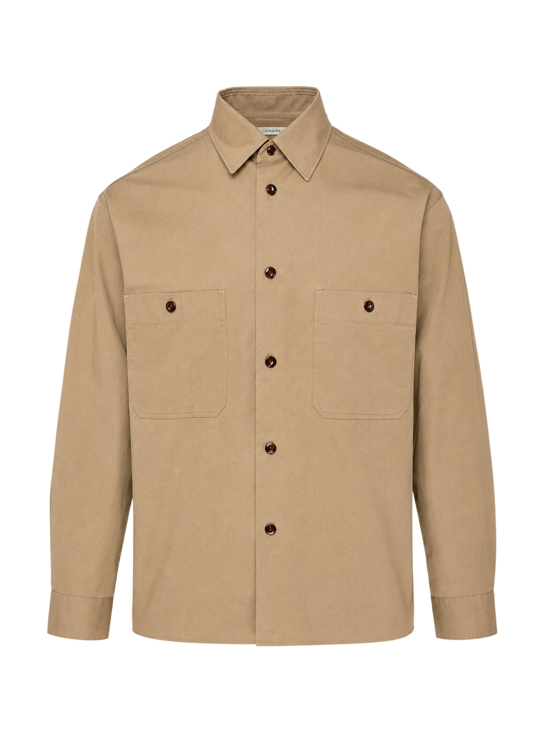 Lemaire Two Pockets Long Sleeve Shirt in tan cotton with dual patch chest pockets, dark tortoiseshell buttons, and a relaxed boxy silhouette, shown on a white background