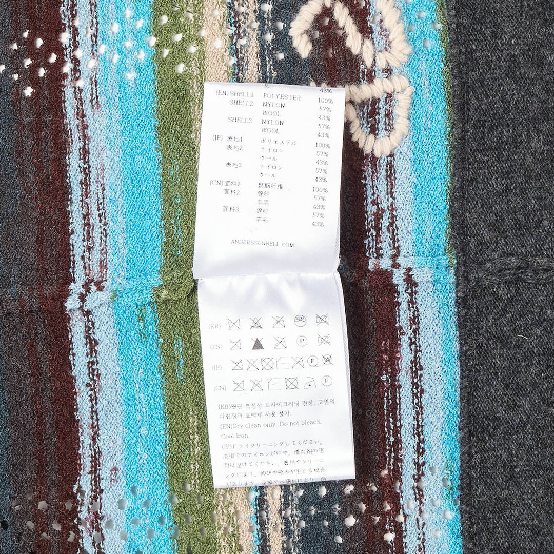 Andersson Bell layered multi-stripe hooded cardigan with teal, burgundy, and green stripe knit body, contrast dark grey hood, snap-button front placket, and intarsia ADSB logo on the lower body