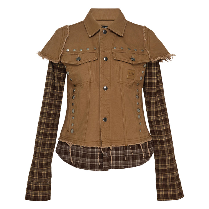 Andersson Bell Layered Studded Vest Shirt — cropped khaki denim vest with silver dome studs and frayed edges over a long-sleeve brown tartan plaid shirt, snap-button front closure and ADSB logo patch