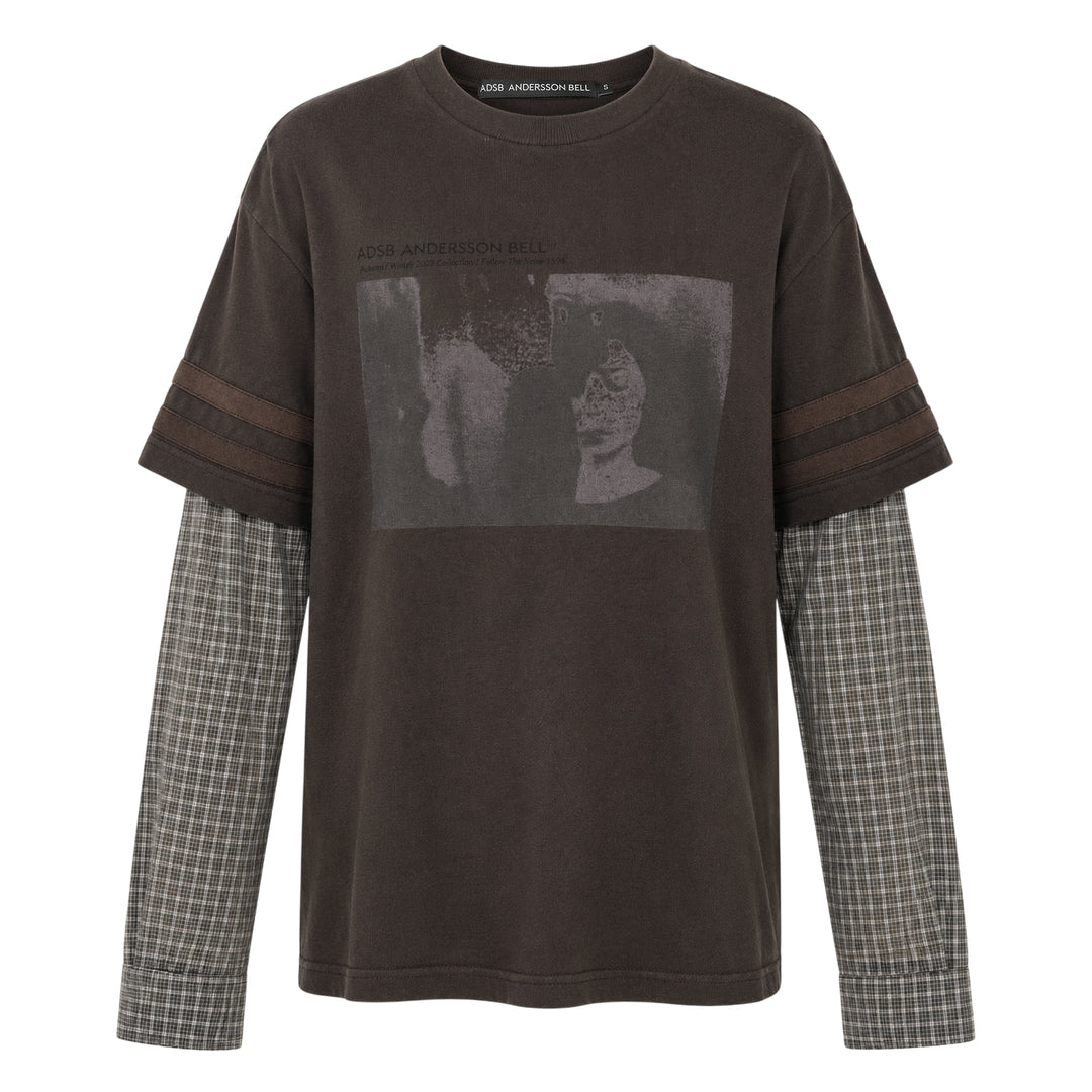 Andersson Bell Layered Sleeve Graphic Tee in washed dark jersey with tonal chest graphic print and green plaid shirting underlayer sleeves, shot flat on white background