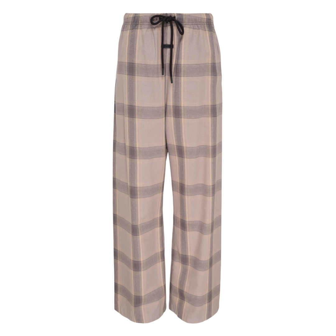 Fear of God Essentials Plaid Lounge Pants in black and cream windowpane check with wide-leg silhouette and elasticated drawstring waistband, flat lay on white background