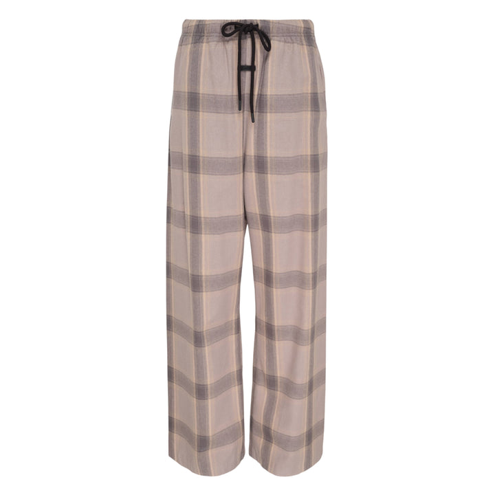 Fear of God Essentials Plaid Lounge Pants in black and cream windowpane check with wide-leg silhouette and elasticated drawstring waistband, flat lay on white background