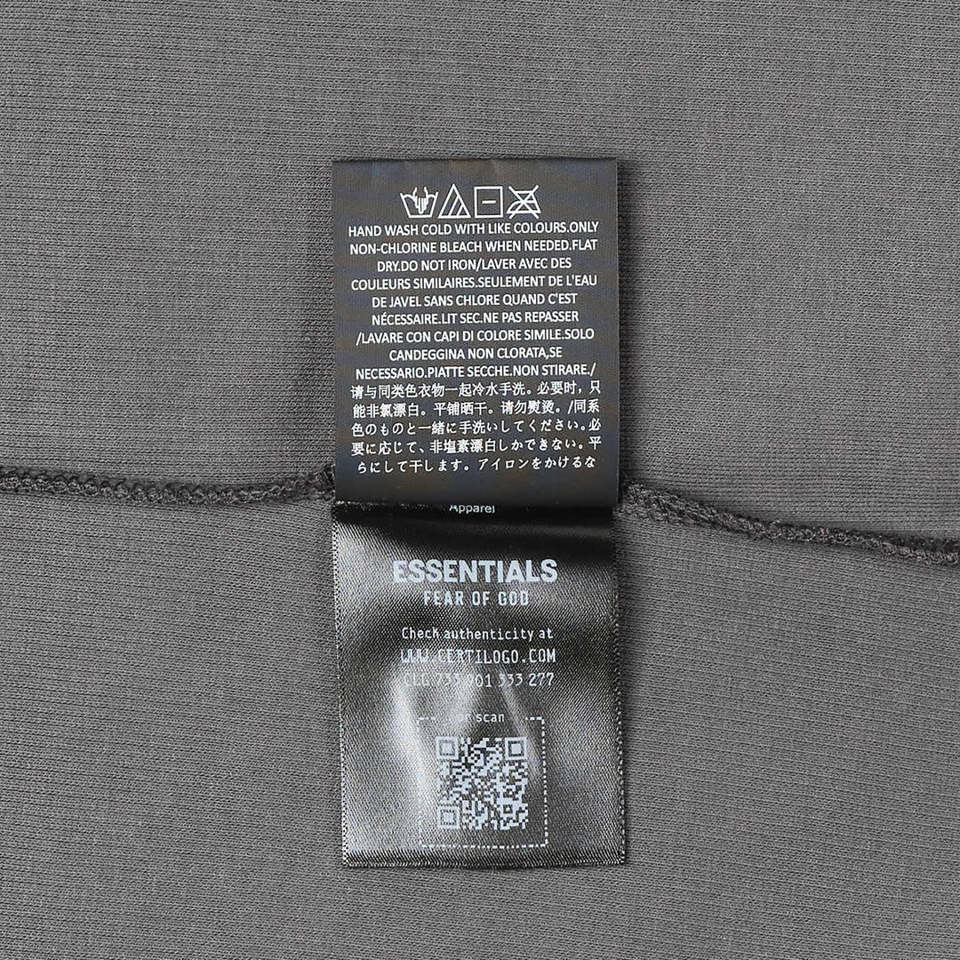 Fear of God Essentials Ribbed Essential Tank in slate grey, featuring a scoop neckline, wide armholes, and a woven brand label at the back neck, displayed flat on a white background