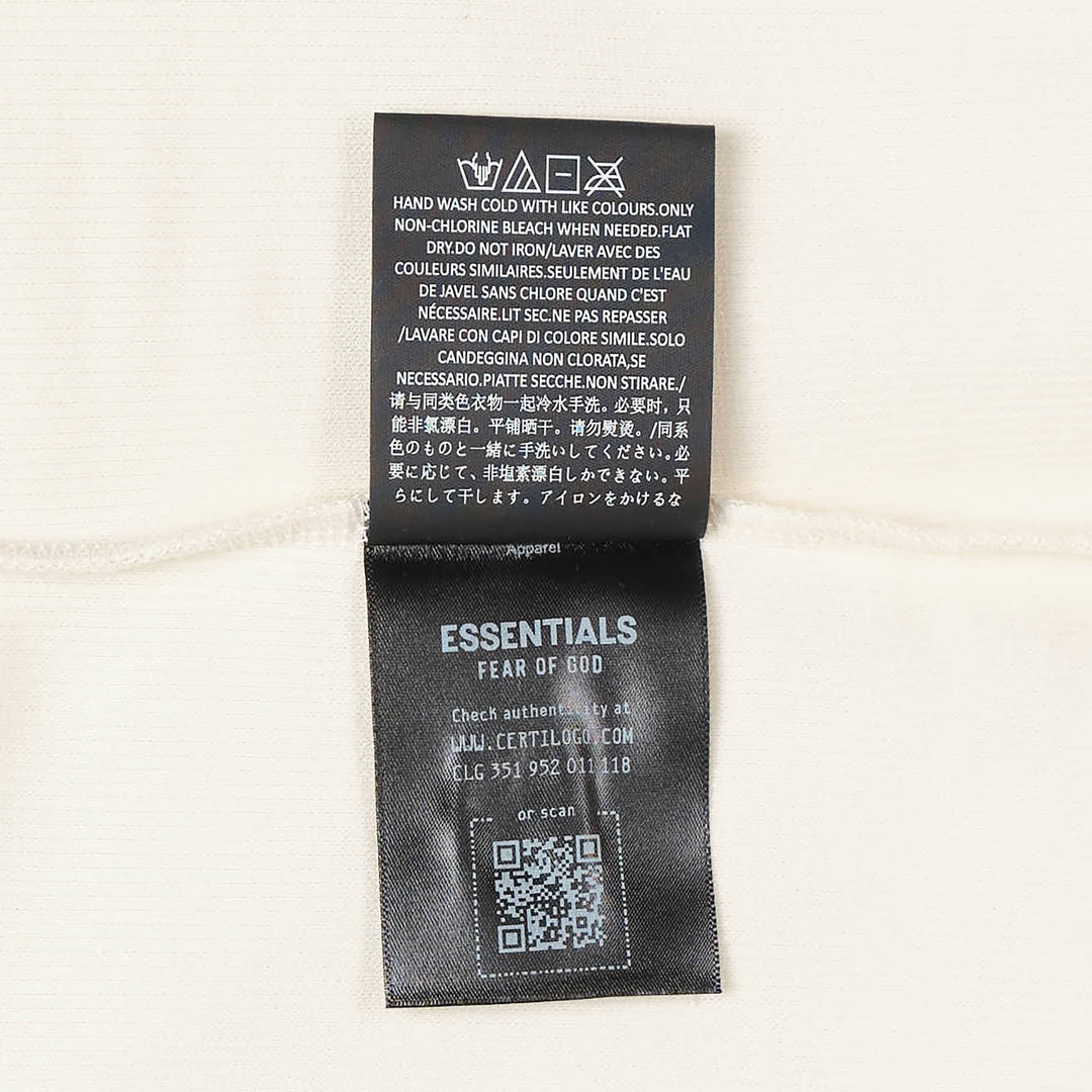 Fear of God Essentials Ribbed Essential Tank in slate grey, featuring a scoop neckline, wide armholes, and a woven brand label at the back neck, displayed flat on a white background