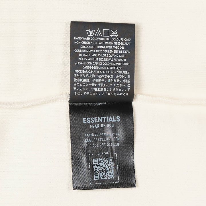 Fear of God Essentials Ribbed Essential Tank in slate grey, featuring a scoop neckline, wide armholes, and a woven brand label at the back neck, displayed flat on a white background
