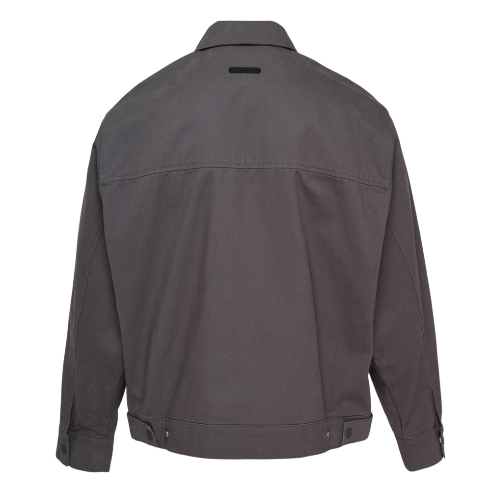 Fear of God Essentials Work Blouson Jacket in charcoal grey with full-zip closure, spread collar, and ribbed hem band, displayed on a flat lay against a white background