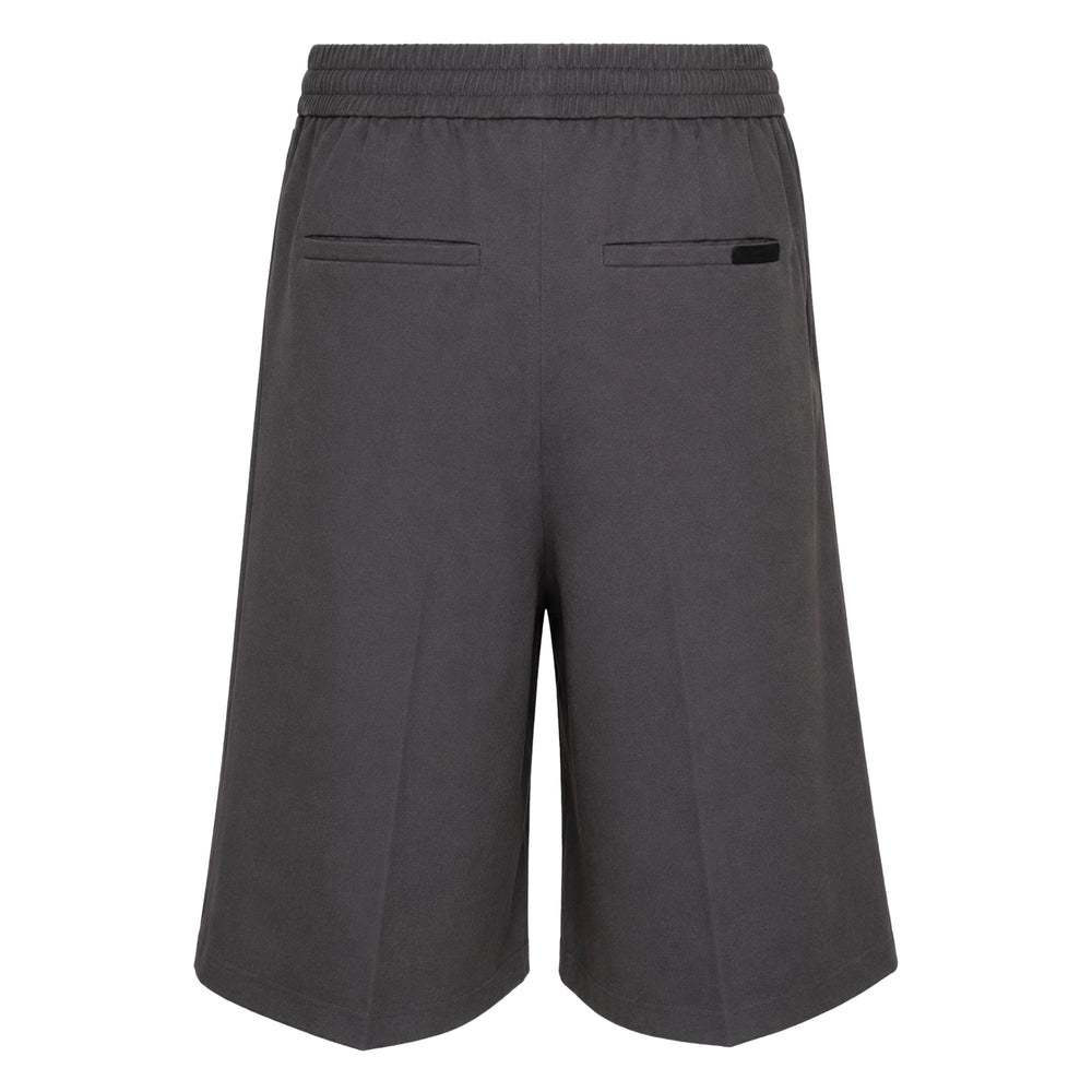 Fear of God Essentials Relaxed Drawstring Shorts in charcoal grey, featuring wide-leg silhouette, pressed front seams, and elasticated drawstring waistband