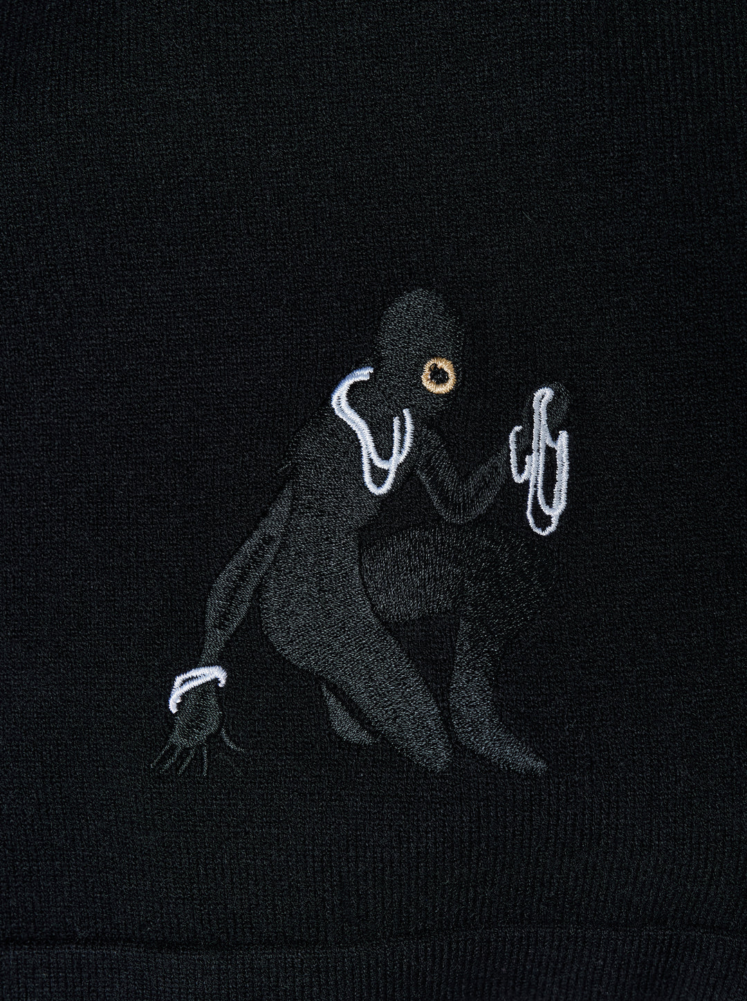 Black knitted pleated trousers with a high banded waist, button fastening and a small embroidered cat burglar motif at the hem - view 4