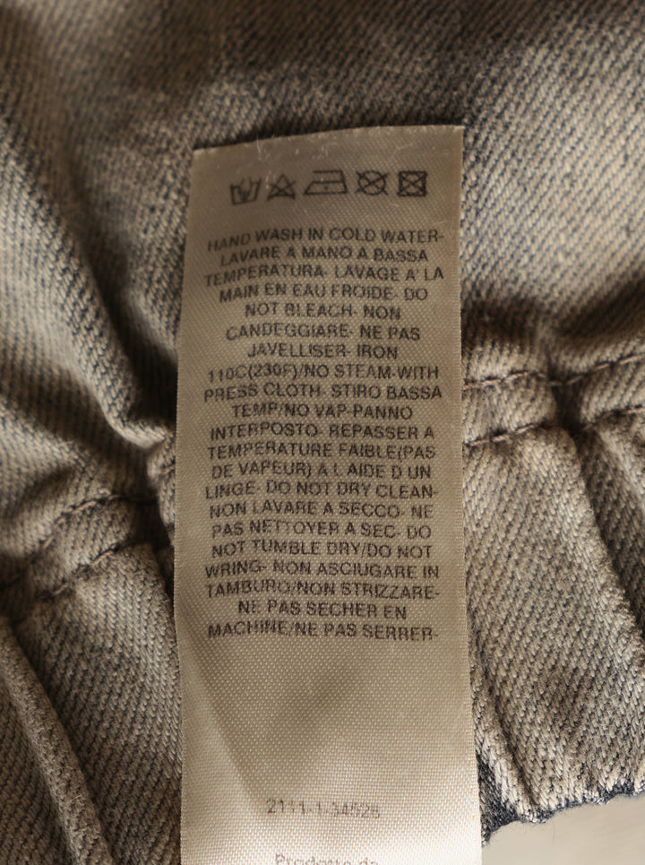 Rick Owens mineral wash denim shorts with elasticated waistband and raw frayed hem in washed beige-grey tone, back view on white background - view 3