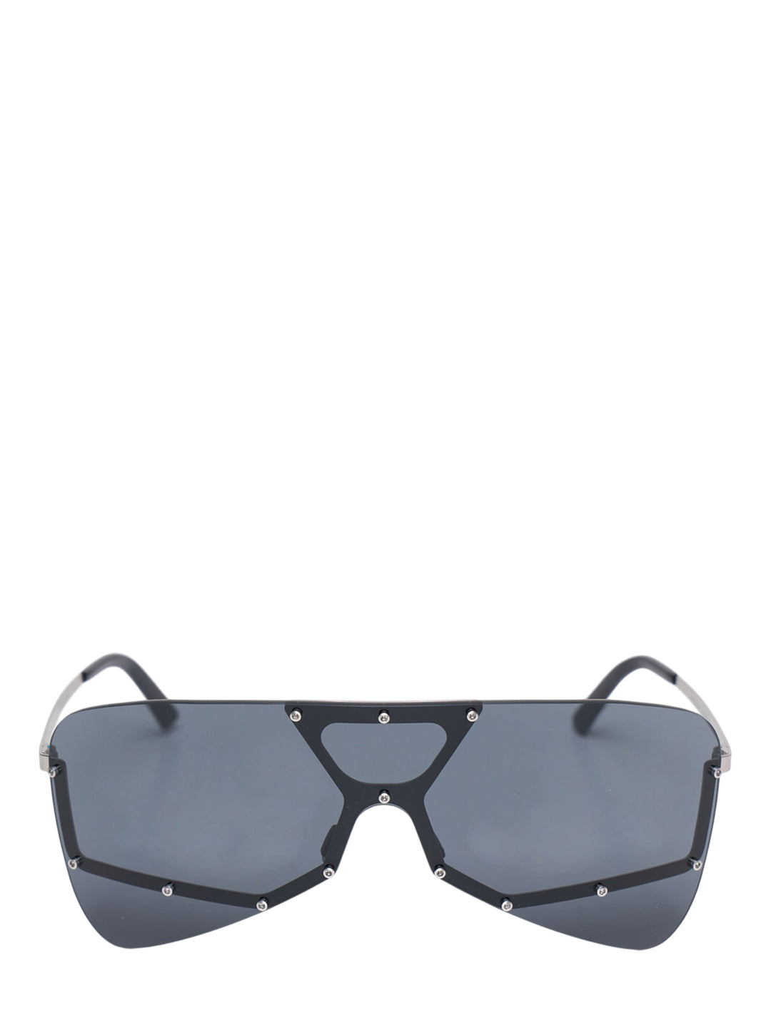 Rick Owens oversized shield mask sunglasses with dark smoke single lens, geometric black frame with triangular bridge cutout, silver stud hardware, and slim metal temples, front view