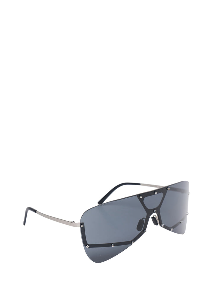 Rick Owens oversized shield mask sunglasses with dark smoke single lens, geometric black frame with triangular bridge cutout, silver stud hardware, and slim metal temples, front view - view 2