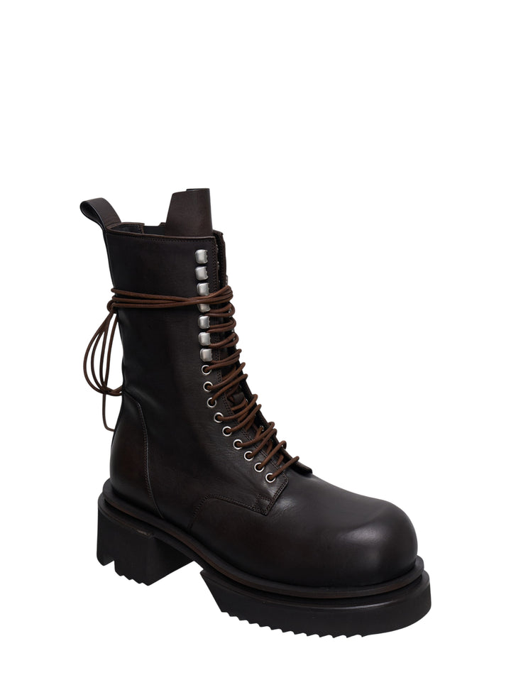 Rick Owens Bogun mid-calf lace-up boots in dark washed calf leather, featuring silver hook hardware, wrap-around brown leather lacing with a raw knot, and an exaggerated black lugged platform sole - view 2