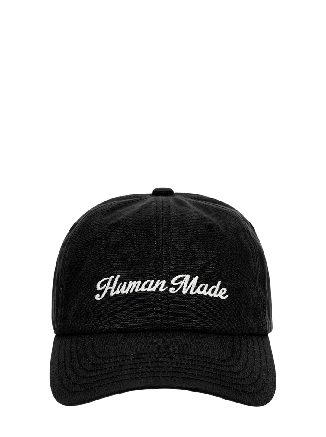 Human Made black 6-panel canvas cap with cream script logo embroidery on the front, shown from the front view