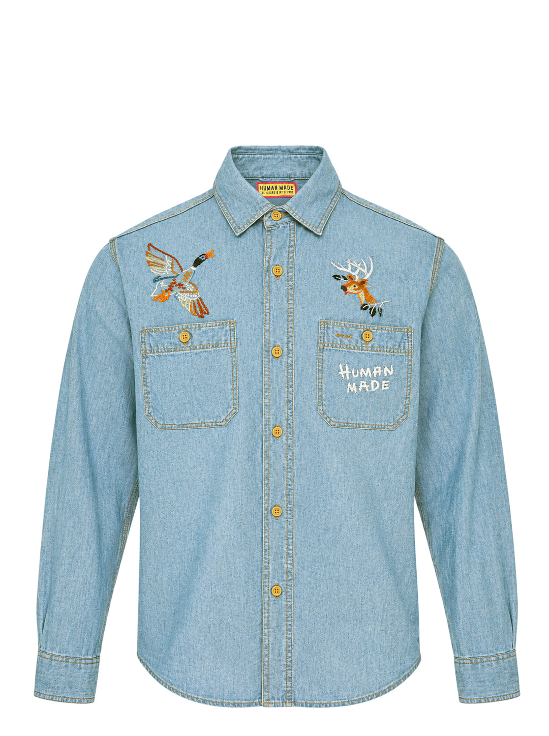 Human Made Embroidered Long Sleeve Chambray Shirt in light-wash denim, featuring a flying duck and deer head embroidery above dual chest pockets, with amber buttons and Human Made script embroidery