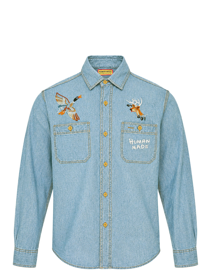 Human Made Embroidered Long Sleeve Chambray Shirt in light-wash denim, featuring a flying duck and deer head embroidery above dual chest pockets, with amber buttons and Human Made script embroidery
