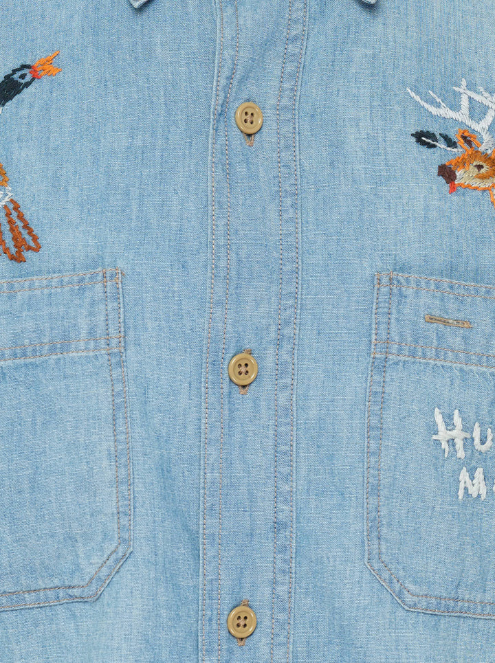 Human Made Embroidered Long Sleeve Chambray Shirt in light-wash denim, featuring a flying duck and deer head embroidery above dual chest pockets, with amber buttons and Human Made script embroidery - view 3