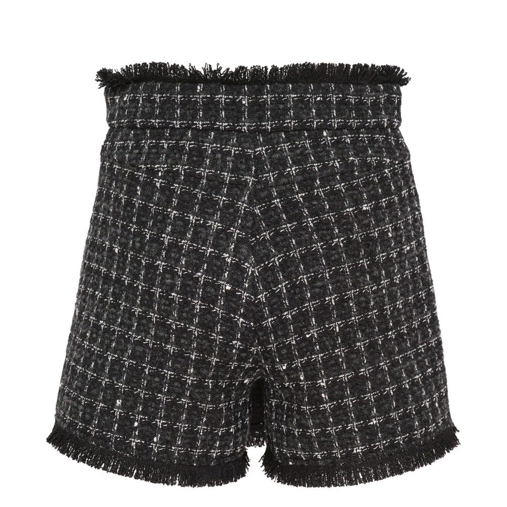 MSGM Checkered Tweed Skorts in black and white boucle weave with fringe-trimmed waistband and hem, wrap-style front, and single button fastening