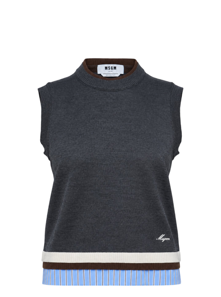 MSGM charcoal grey sleeveless knit vest with dark brown mock neck trim, trompe-l'œil striped shirting hem detail, and embroidered MSGM script logo at the front hem
