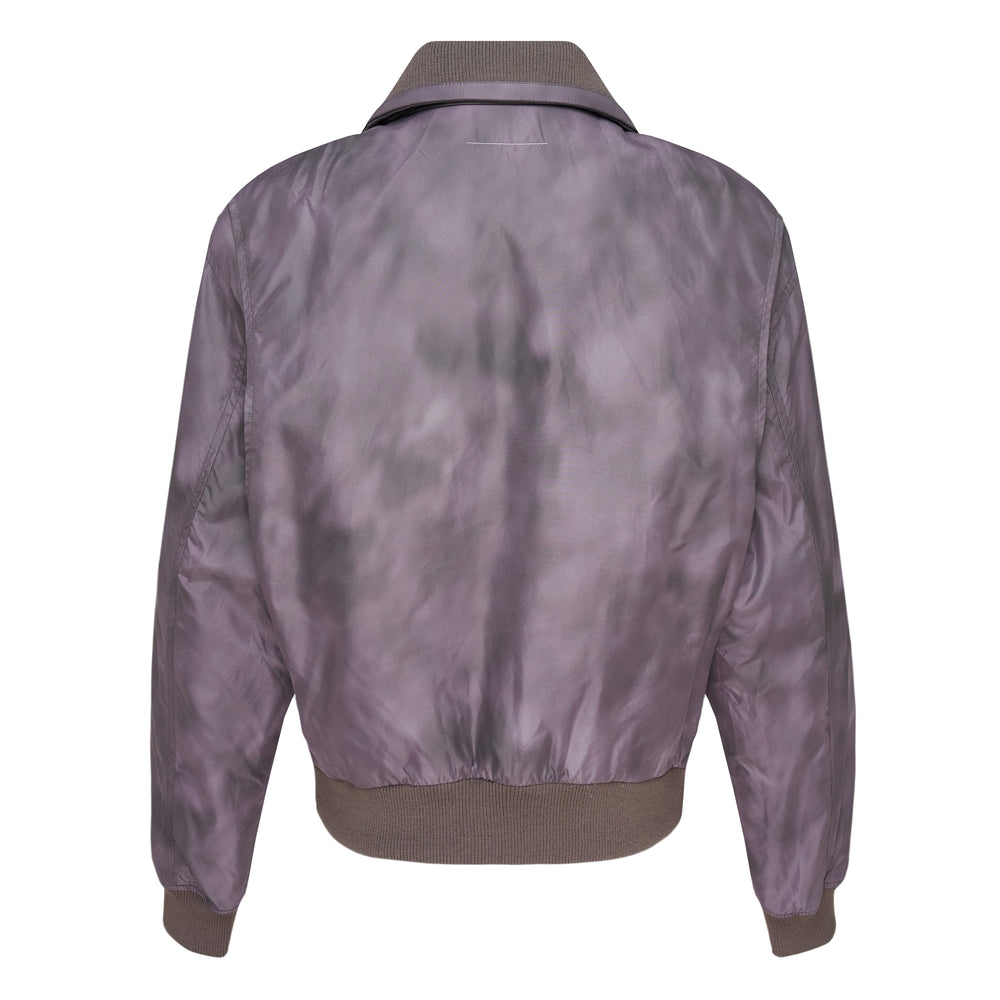 MM6 Maison Margiela Sky Dye Nylon Sports Jacket in muted violet with clouded dye pattern, spread collar, full-length zip, dual chest flap pockets, and ribbed knit cuffs and hem