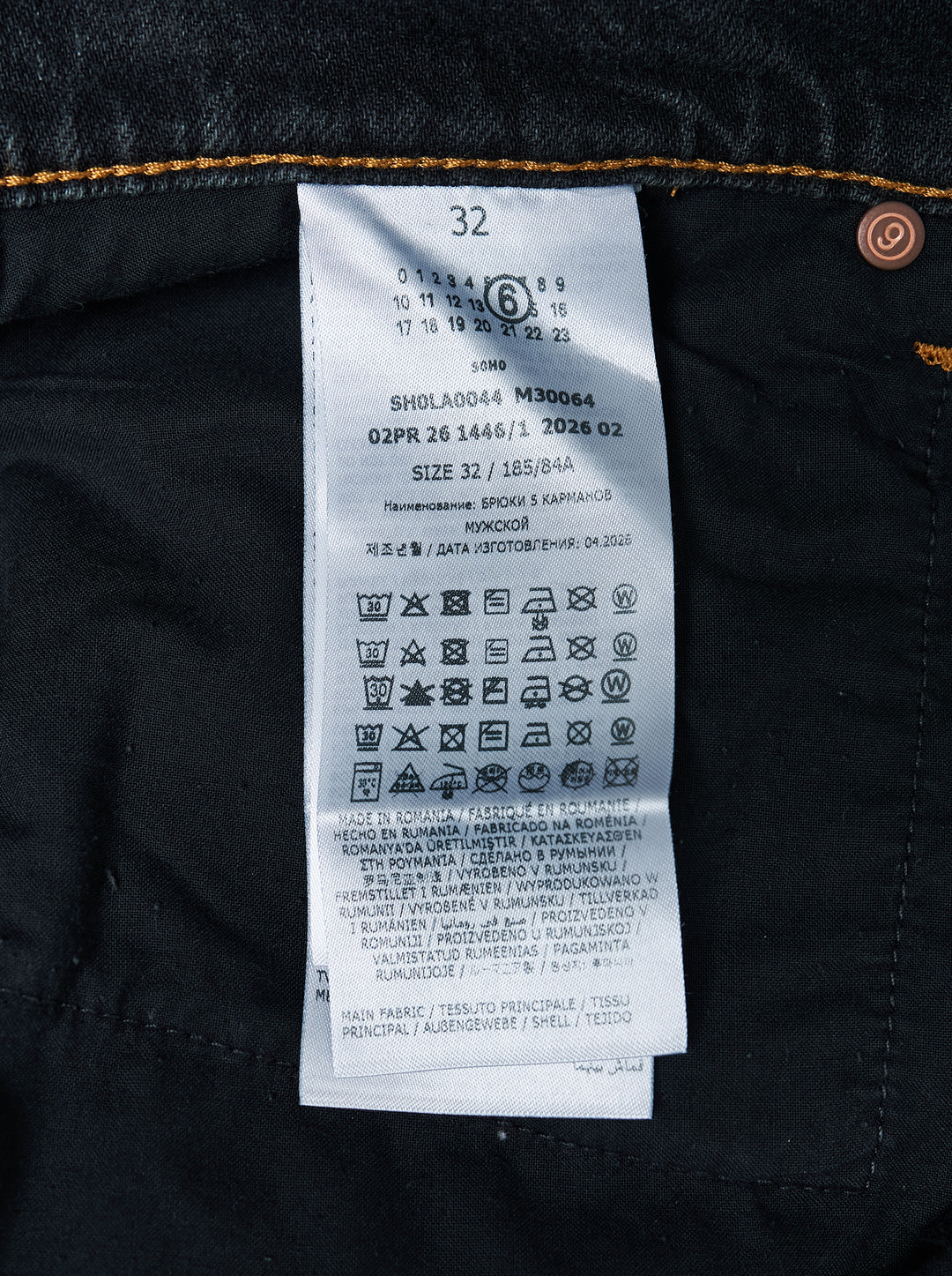 MM6 Maison Margiela black washed denim five-pocket jeans with distressed knee slit and straight leg, front view - view 3