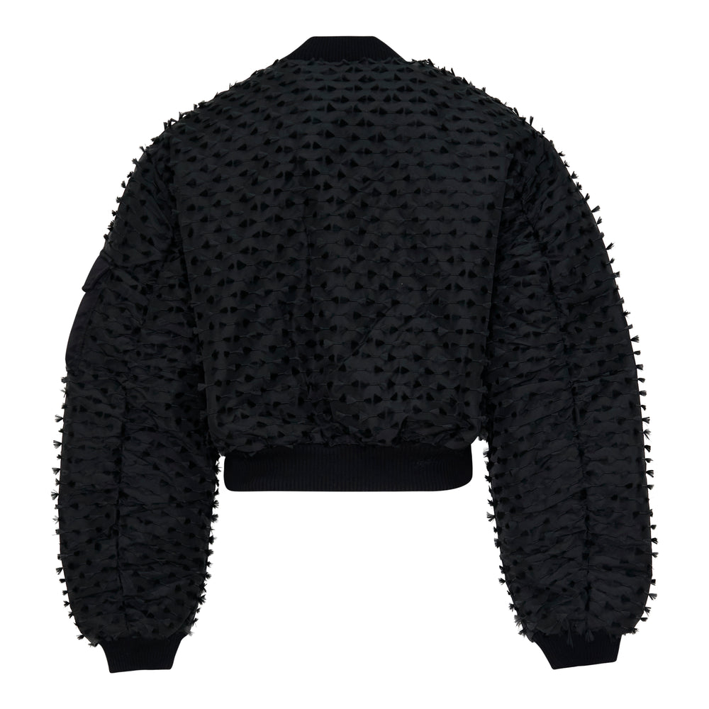 Cecilie Bahnsen Fiamma Fil Coupé Bomber Jacket in black, displayed flat, showing all-over cut textile motifs, dual chest utility pockets, ribbed cuffs and hem, and centre-front zip closure