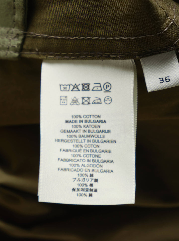 Dries Van Noten olive green straight cargo midi skirt with four snap-button flap pockets, contrast topstitching, and a centre-front vent, on a white background - view 3