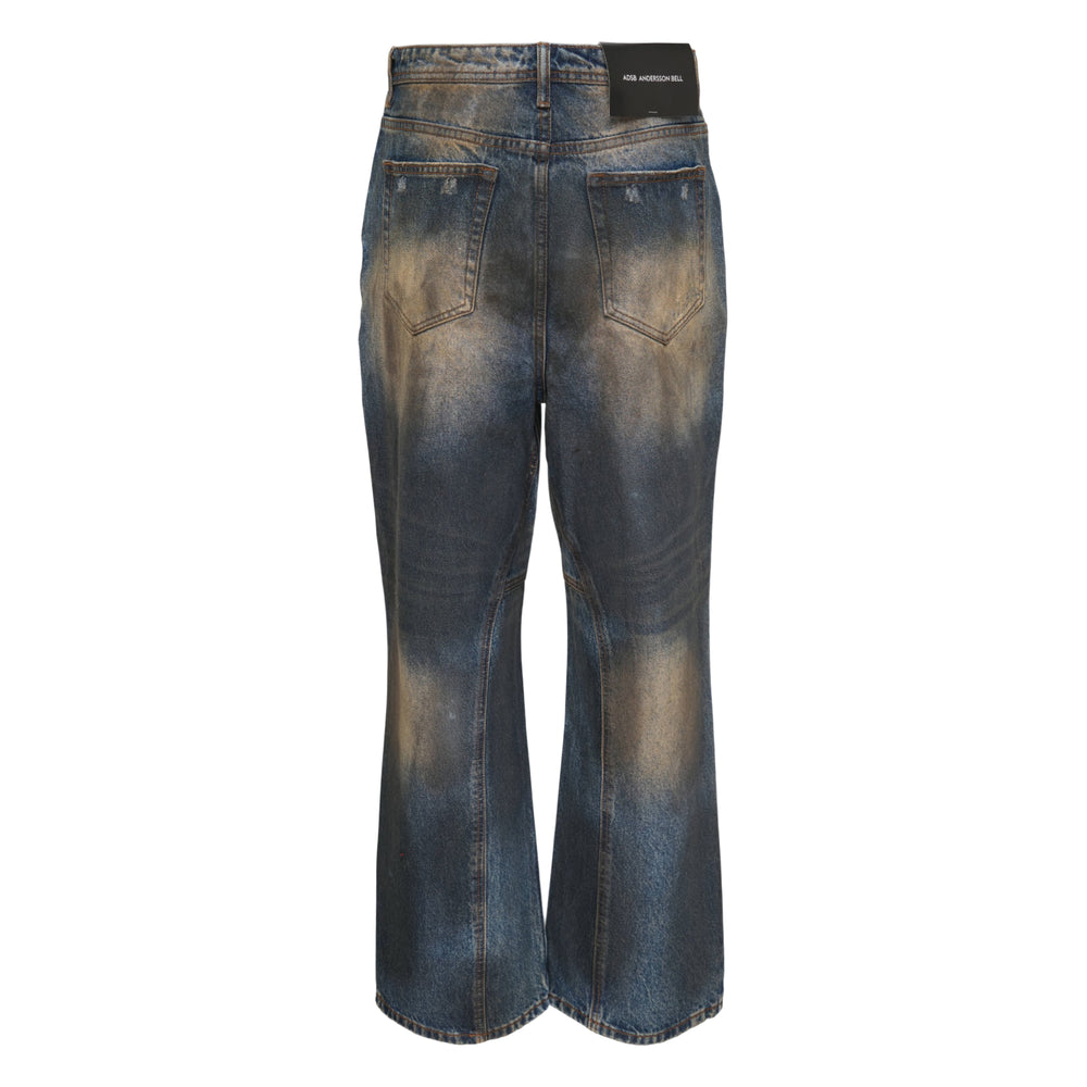Andersson Bell Unisex Coated Blue Wide-Leg Jeans with heavy mud-dye vintage wash, sand-bleached fading across the thighs, five-pocket construction, and copper-tone button fly hardware
