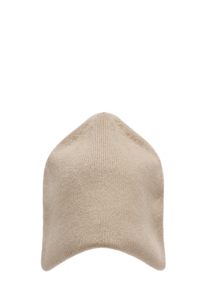 Beige knit hat with a pointed crown and curved brim by Homme Plissé Issey Miyake, from the Winter Gear collection