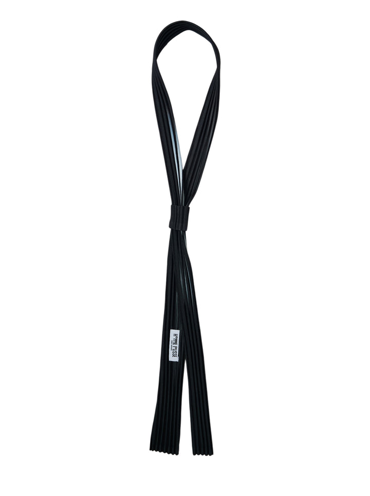 Black pleated slim tie by Homme Plissé Issey Miyake with a sliding keeper, shown looped against a white background - view 2