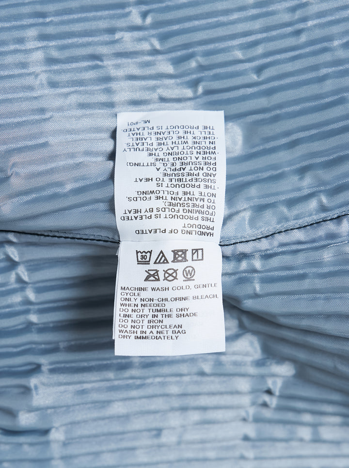 Black micro-pleated single-button jacket by Homme Plissé Issey Miyake with notched lapels and a blurred pale blue shadow print across the front - view 3