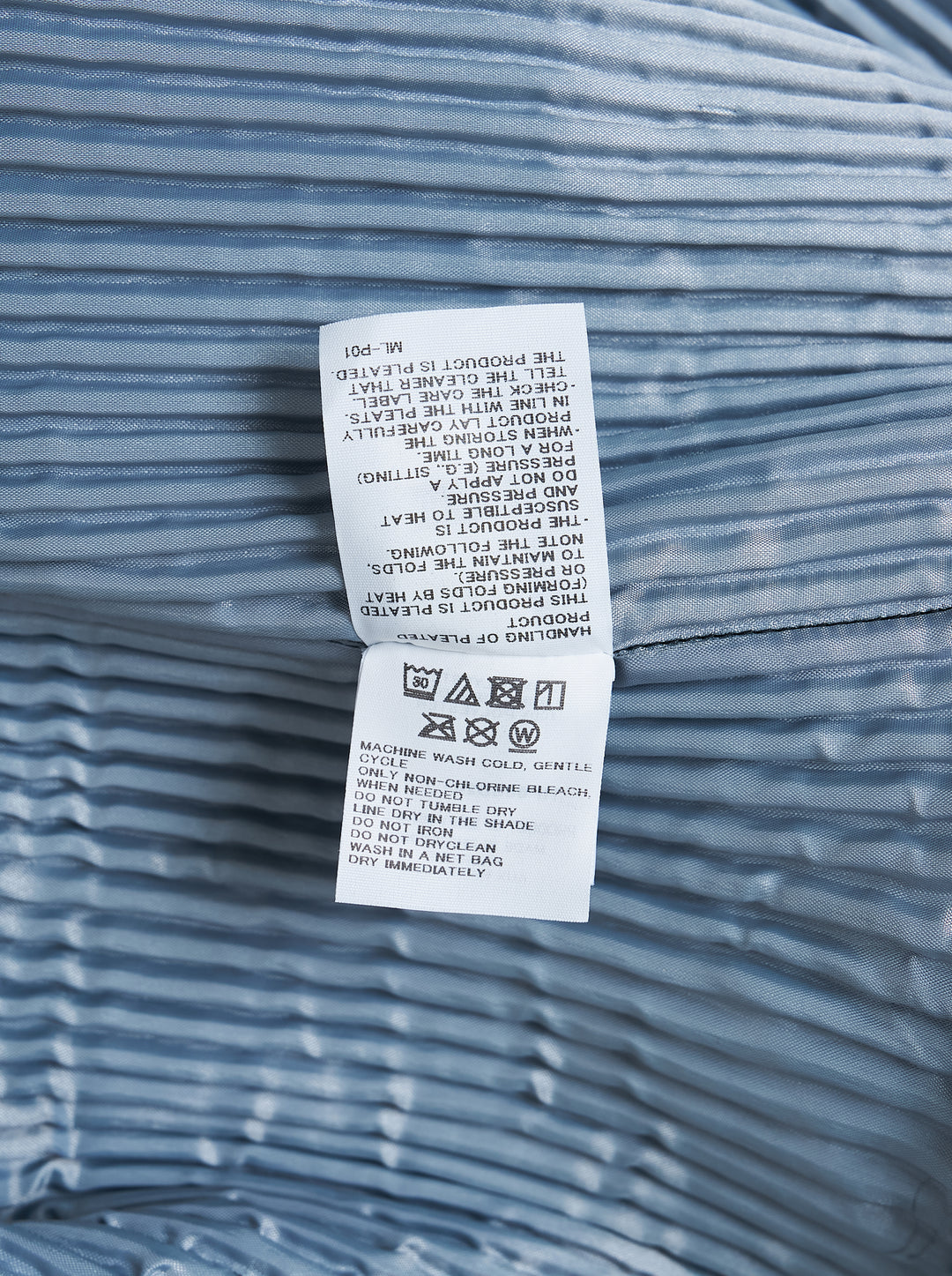 Homme Plissé Issey Miyake In The Shadow long pleated coat in black with blurred pale blue brushstroke print and light blue lining at the collar - view 3