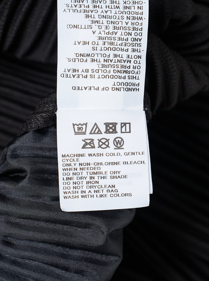 Homme Plissé Issey Miyake Compleat Pleated Trousers in black, shown flat with all-over permanent pleating and elasticated waistband - view 3