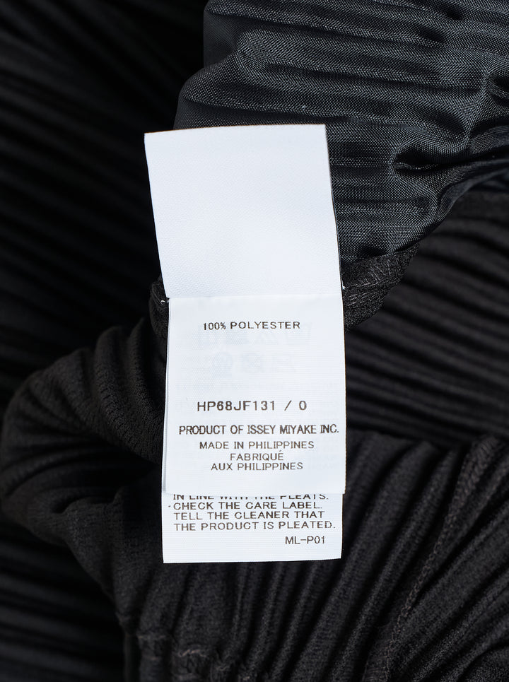 Homme Plissé Issey Miyake Compleat Pleated Trousers in black, shown flat with all-over permanent pleating and elasticated waistband - view 4