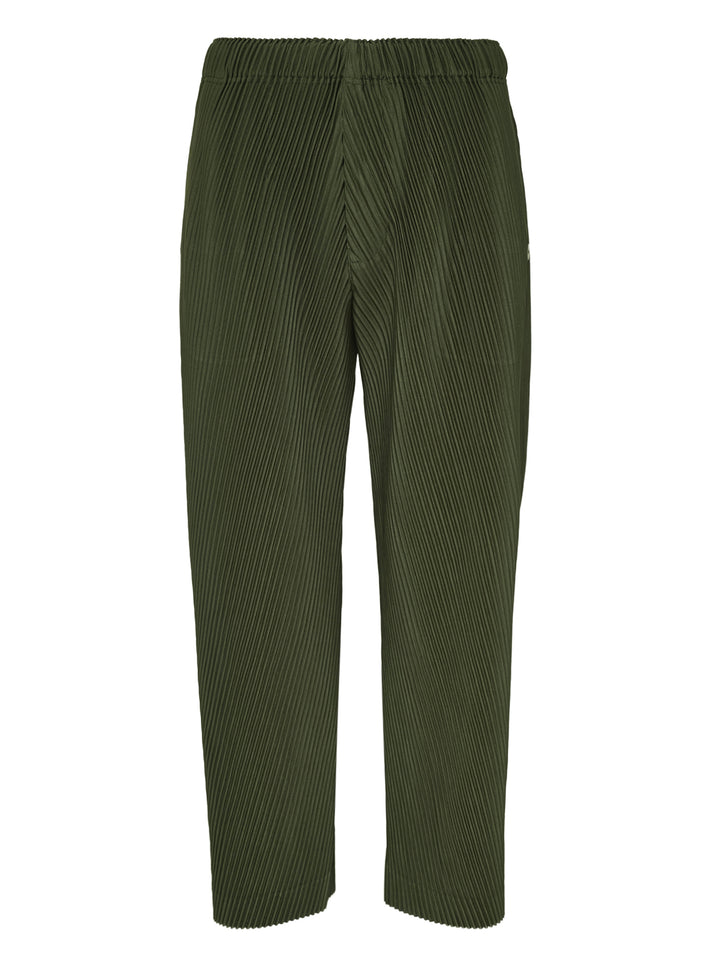 Homme Plissé Issey Miyake Slash Pleated Pants in olive green with signature diagonal micro-pleat construction and elastic waistband, relaxed tapered silhouette
