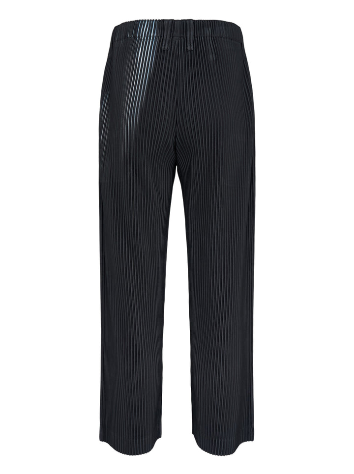 Homme Plissé Issey Miyake In The Shadow pleated pants in black with a blurred grey-blue vertical stripe print, shown from the front - view 2