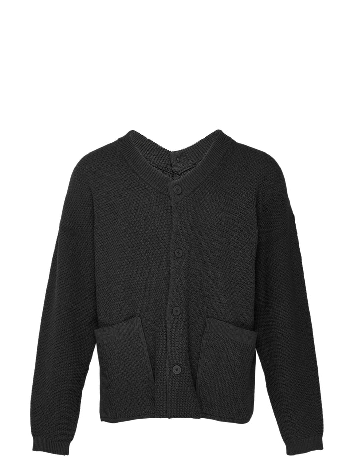 Homme Plissé Issey Miyake Rustic Knit Cardigan in charcoal, featuring a ribbed V-neckline, tonal button-through front, pebbled knit body, and two smooth-panel patch pockets at the hem