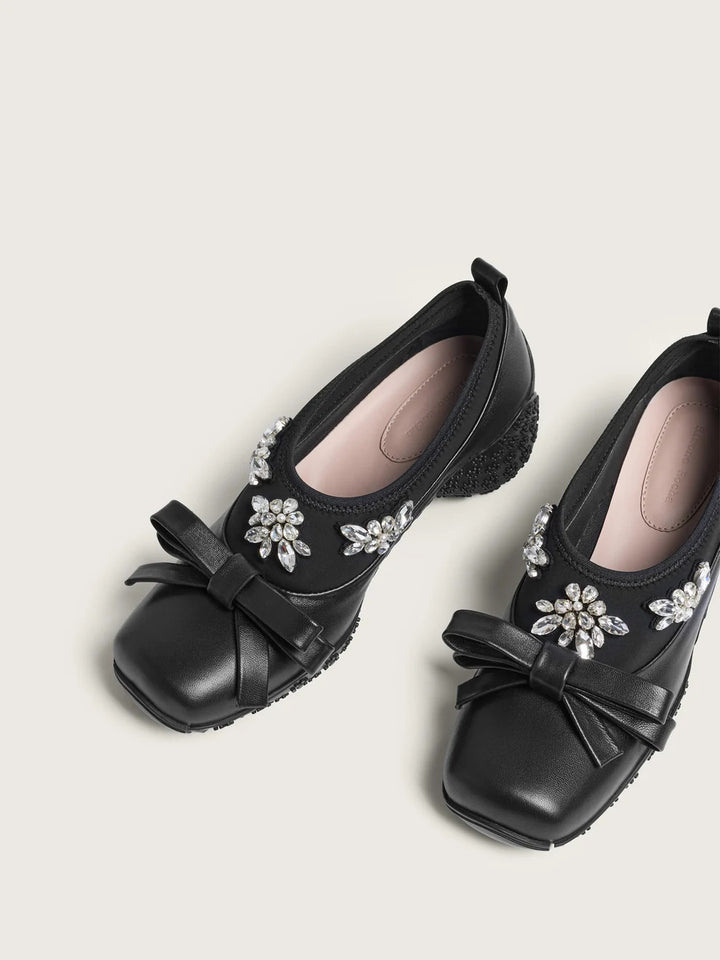 Simone Rocha black Bow Ballet Runner with a neoprene upper, crystal flower embellishment, a leather bow and a floral-studded sole, shown in side profile - view 2