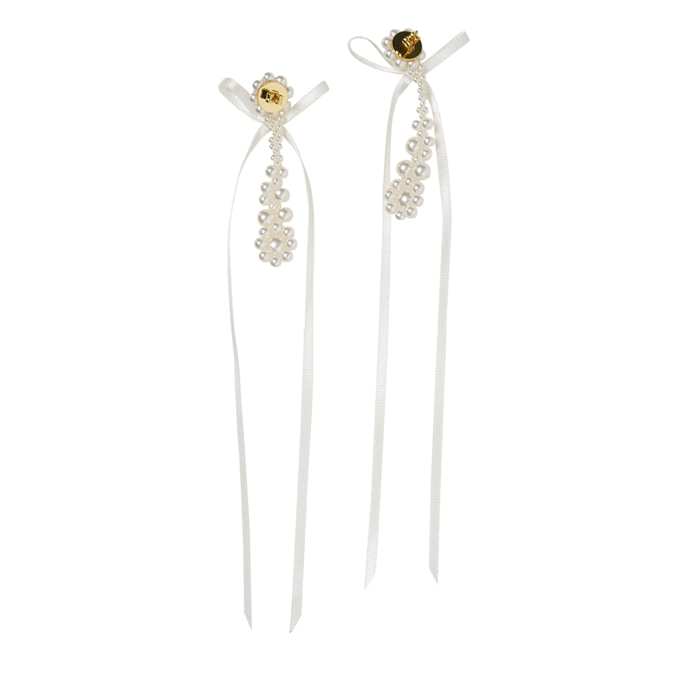 Simone Rocha Victorian Drip Bow Earrings featuring pearl flower cluster studs, ivory satin ribbon bows, cascading pearl drops, and long trailing ribbon tails