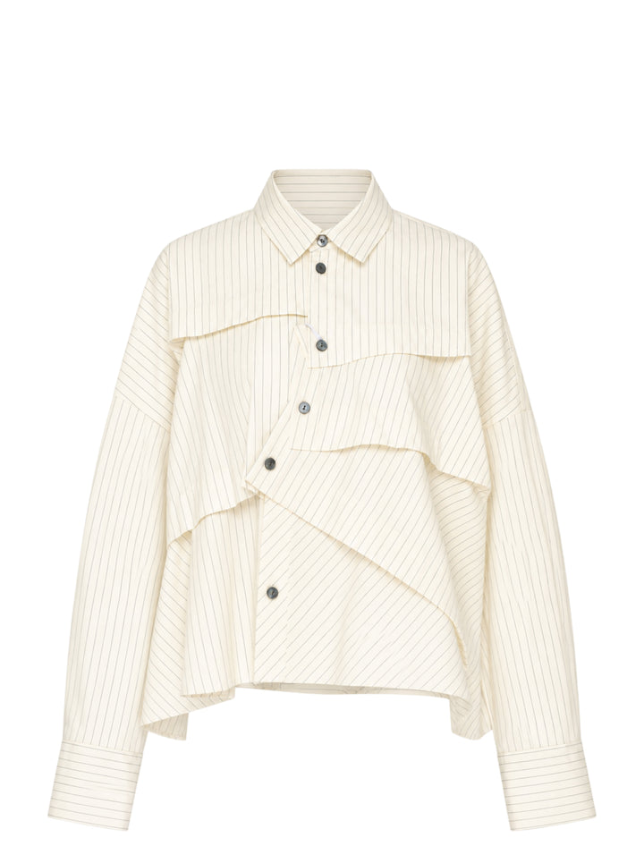 Enfold Striped Wide Tucked Shirt in cream pinstripe fabric, featuring asymmetric layered tuck panels across the front, a point collar, gunmetal buttons, and wide cuffed long sleeves