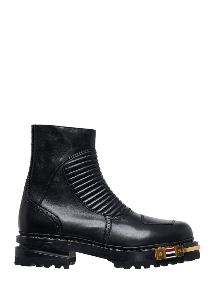 Thom Browne black leather quilted hiking moto boot with ribbed panelling, brogue detailing, lugged sole and gold-tone tricolour heel plate